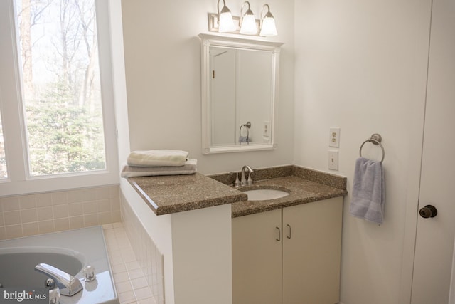 bathroom featuring a washtub and vanity