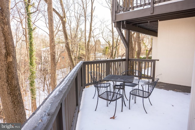 snow covered deck with outdoor dining area