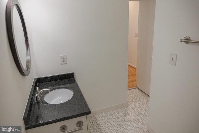 bathroom with vanity, baseboards, and tile patterned floors