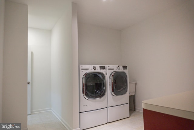 laundry room featuring laundry area, independent washer and dryer, and baseboards