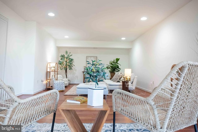 living room featuring recessed lighting, baseboards, and wood finished floors