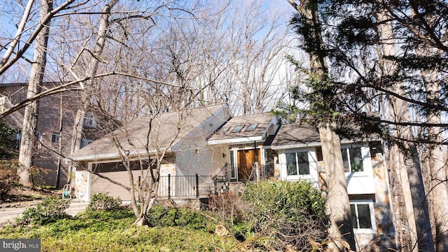 view of front facade featuring a garage, concrete driveway, and stucco siding