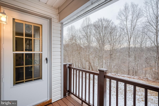 view of snow covered back of property