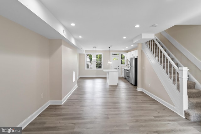 unfurnished living room with light hardwood / wood-style floors