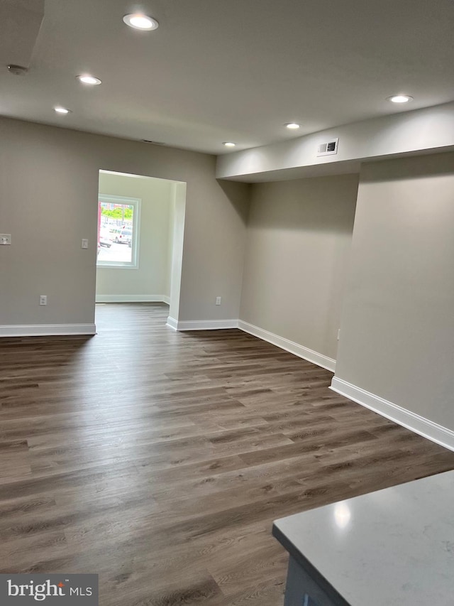 spare room featuring dark wood-type flooring