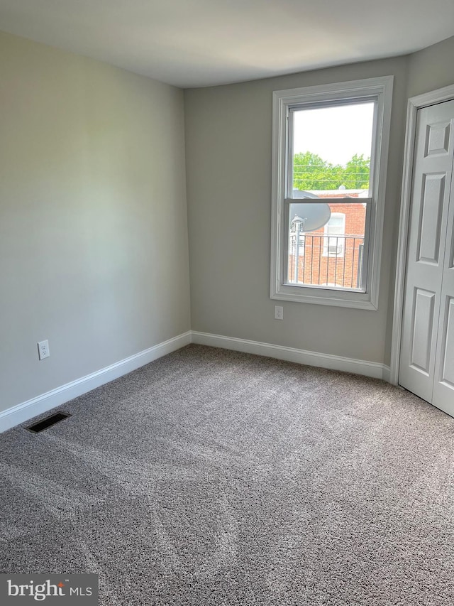 spare room featuring carpet floors