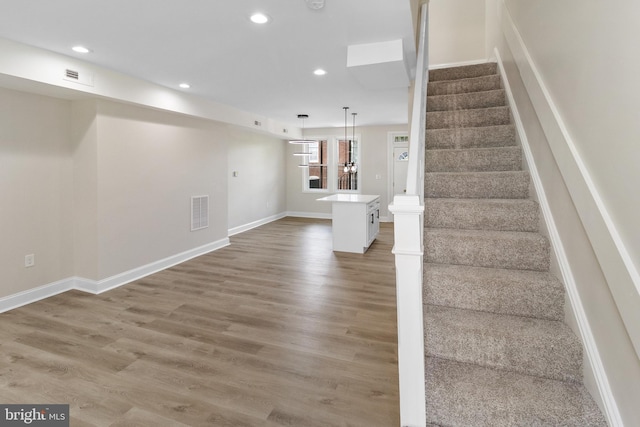 stairway featuring hardwood / wood-style floors