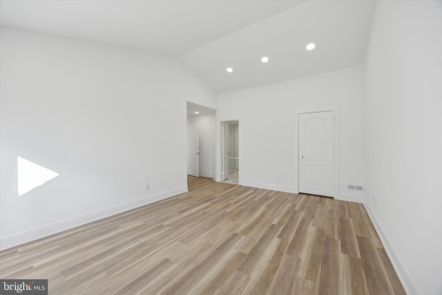 unfurnished bedroom with light hardwood / wood-style flooring and vaulted ceiling