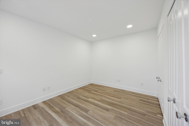 unfurnished room with hardwood / wood-style flooring