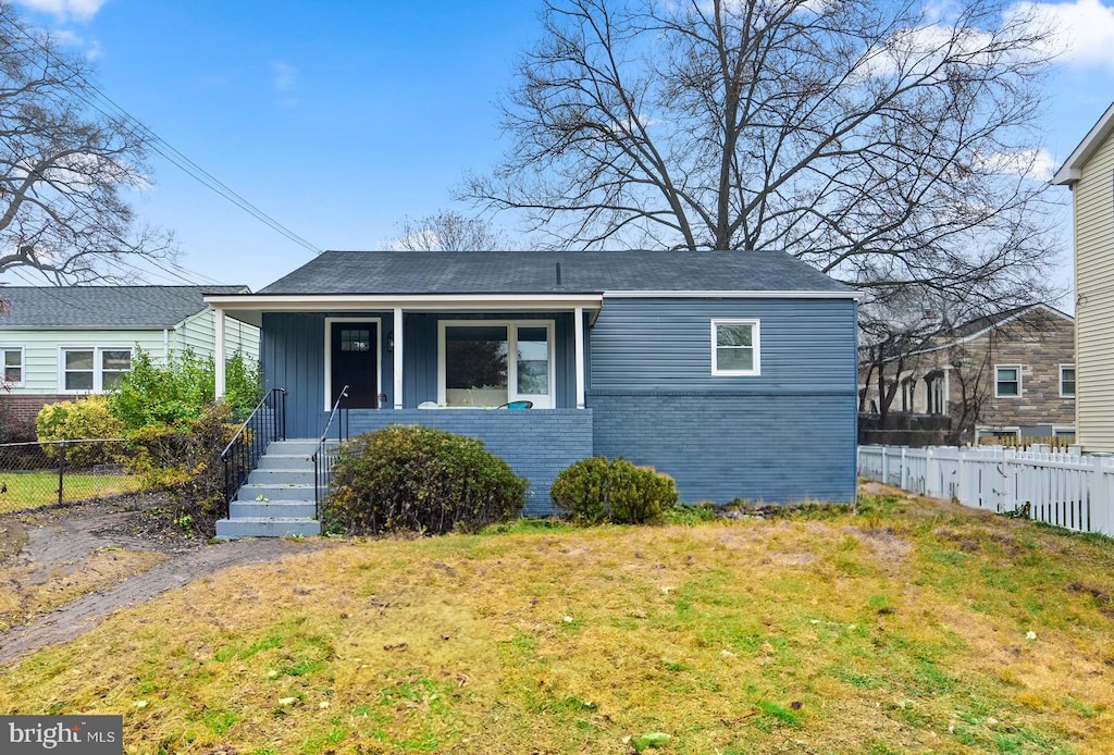 bungalow-style home featuring a porch and a front lawn