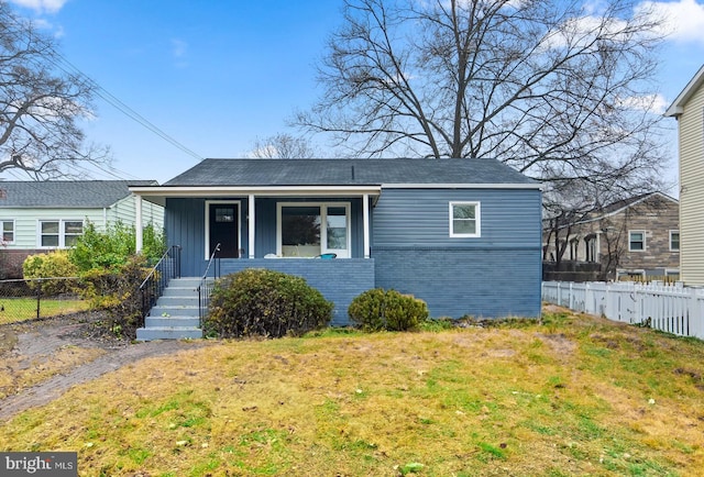 bungalow-style home featuring a porch and a front lawn