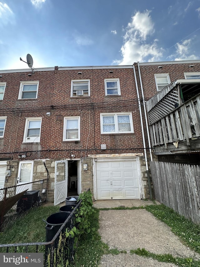 rear view of property with a garage