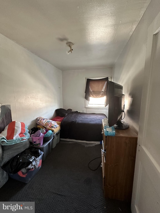 bedroom featuring carpet floors and a textured ceiling