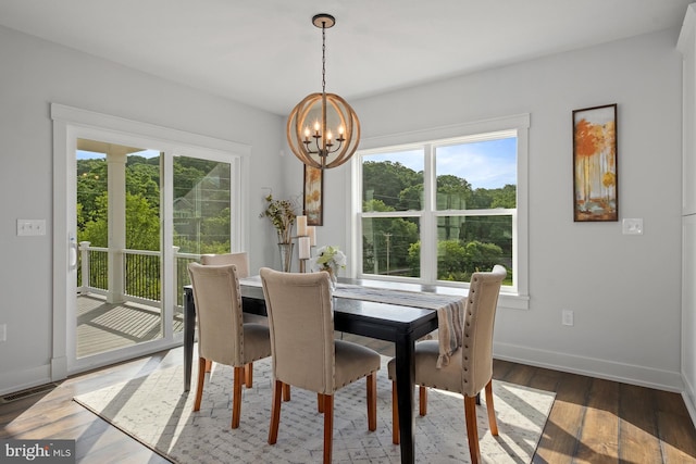 dining space with a notable chandelier and dark hardwood / wood-style floors