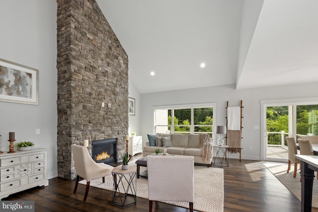 living room featuring a fireplace, dark hardwood / wood-style floors, and high vaulted ceiling