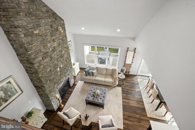 living room with dark wood-type flooring and a fireplace