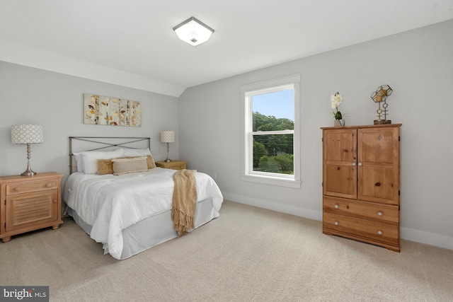 carpeted bedroom featuring lofted ceiling