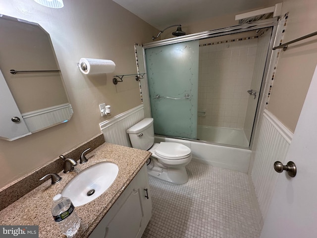 full bathroom with toilet, tile patterned floors, vanity, and enclosed tub / shower combo