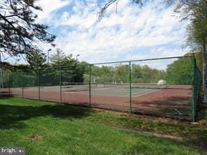 view of sport court with a lawn