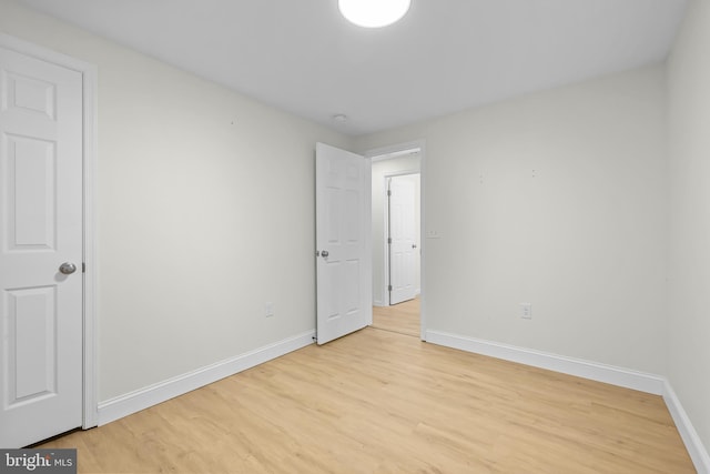 empty room with light hardwood / wood-style floors