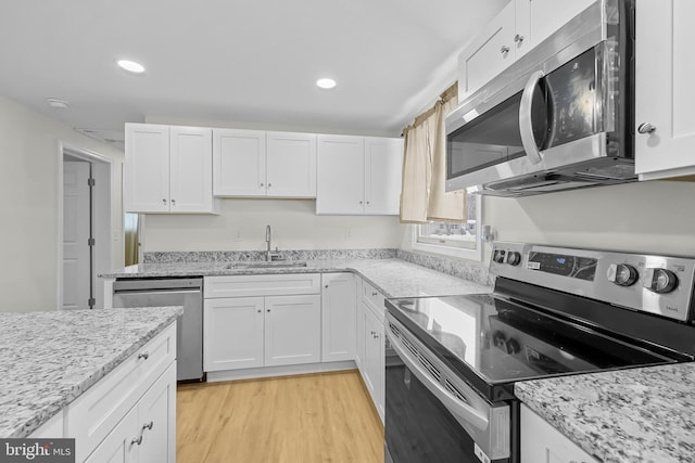 kitchen featuring sink, stainless steel appliances, and white cabinets