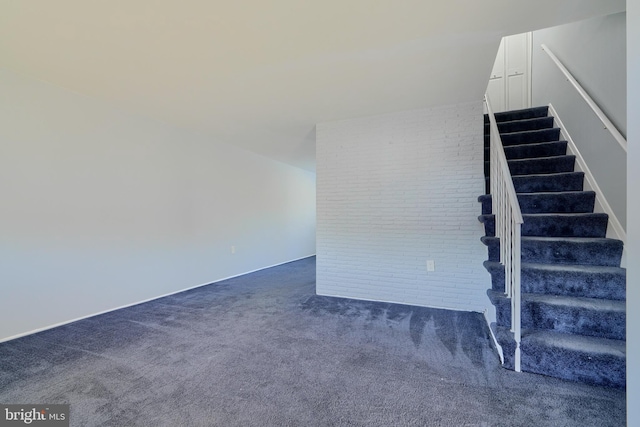 stairway with brick wall and carpet