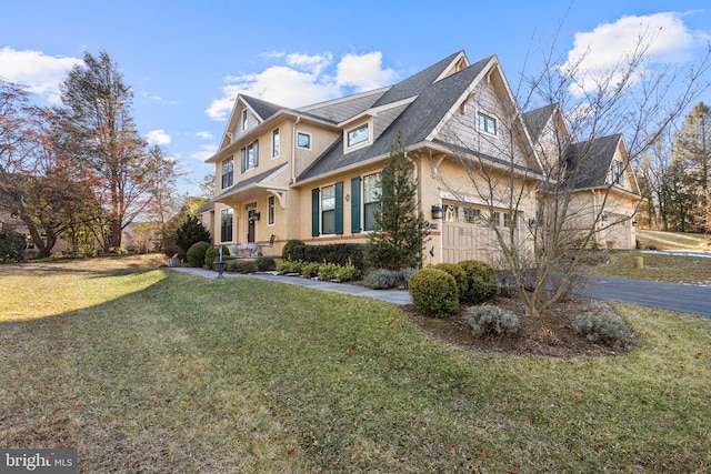 view of front of property with a front lawn and a garage