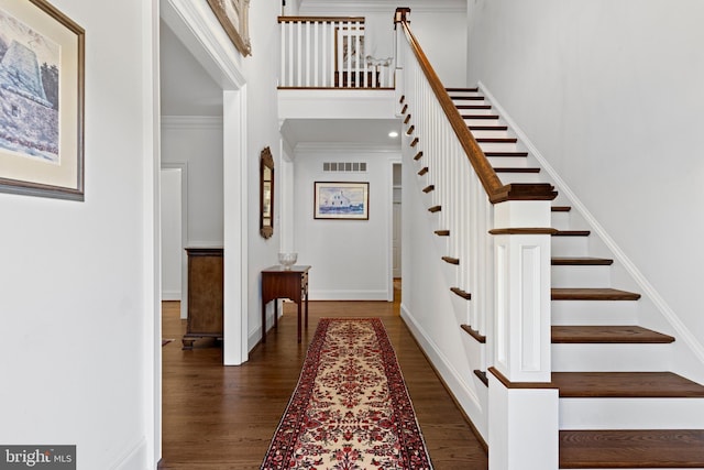 interior space featuring hardwood / wood-style flooring and crown molding