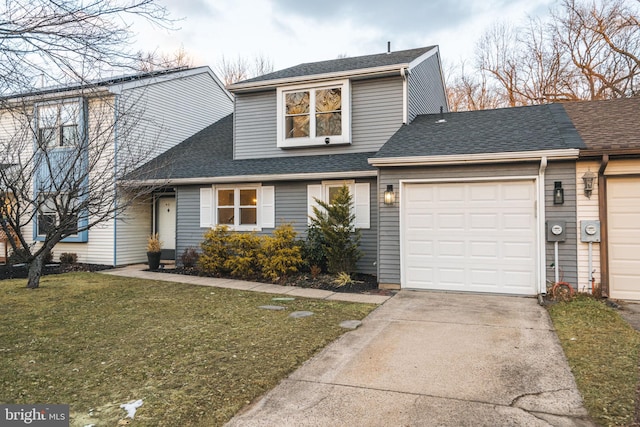 view of front of property featuring a garage and a front lawn