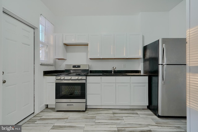 kitchen with white cabinets, appliances with stainless steel finishes, and sink