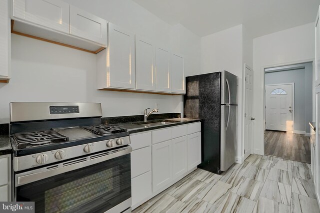 kitchen with sink, white cabinetry, and appliances with stainless steel finishes