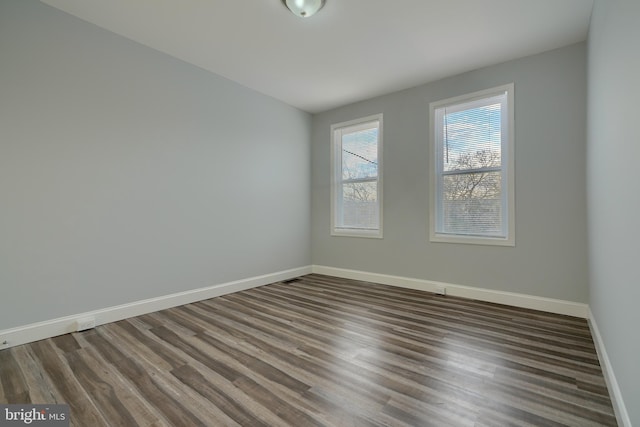 empty room featuring dark hardwood / wood-style flooring