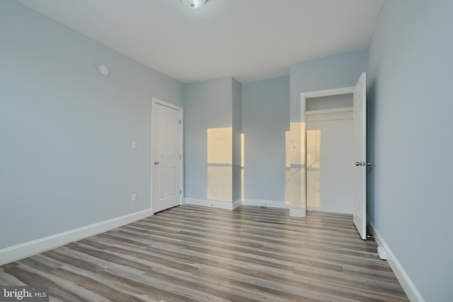 unfurnished bedroom with a closet and light wood-type flooring