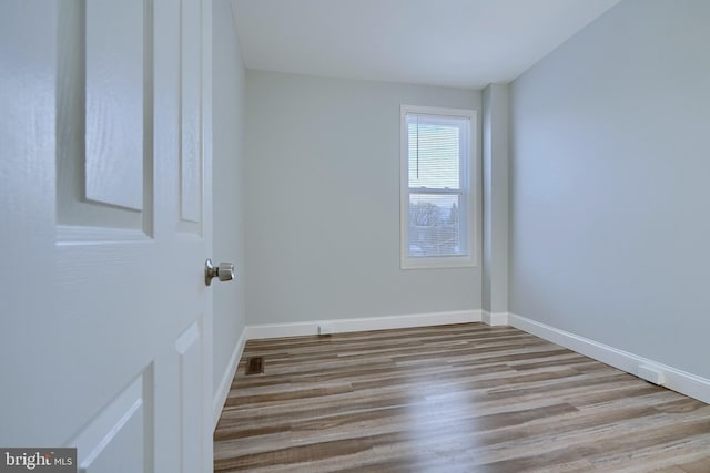 spare room with light hardwood / wood-style flooring