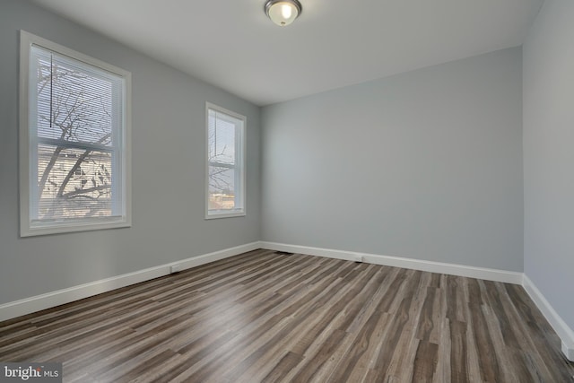 empty room featuring dark wood-type flooring