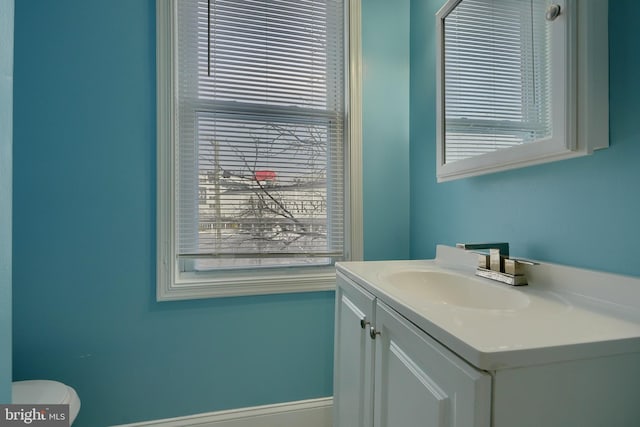 bathroom featuring toilet and vanity