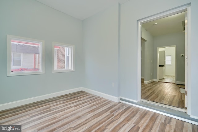 empty room with light hardwood / wood-style flooring