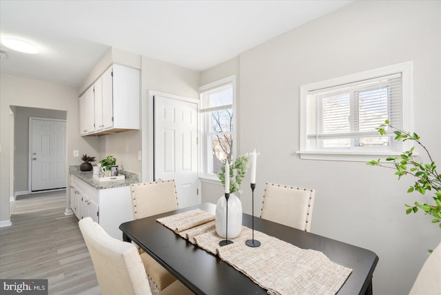 dining area featuring light hardwood / wood-style floors and a wealth of natural light