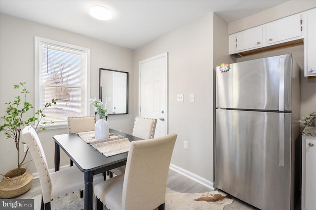 dining area with light hardwood / wood-style floors