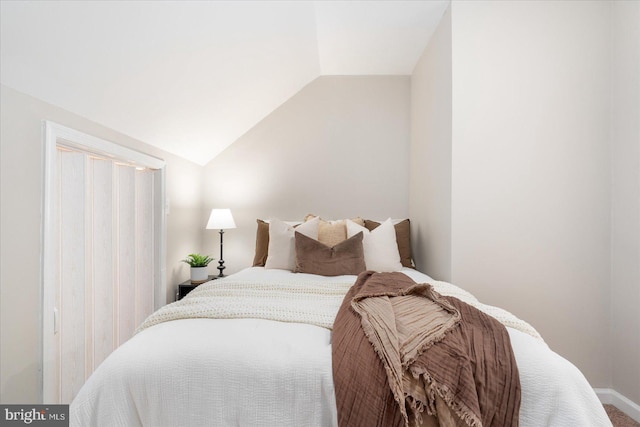 bedroom featuring lofted ceiling