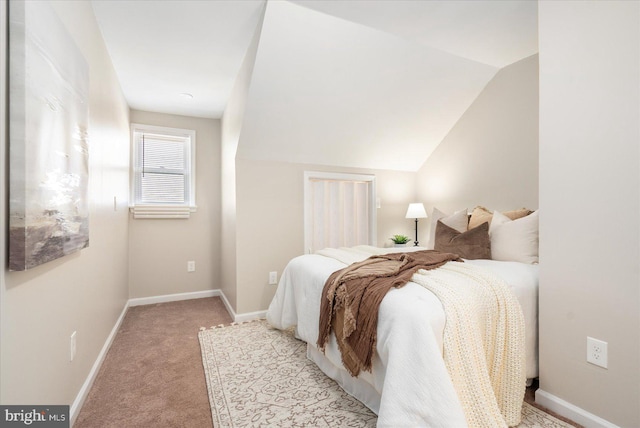 carpeted bedroom featuring vaulted ceiling