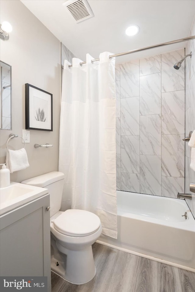 full bathroom with toilet, shower / bath combination with curtain, wood-type flooring, and vanity