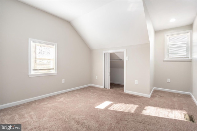 additional living space with lofted ceiling and carpet