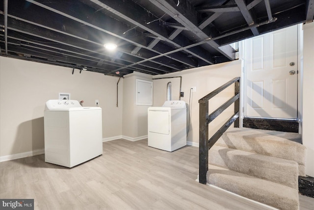 basement with washer and clothes dryer and hardwood / wood-style floors