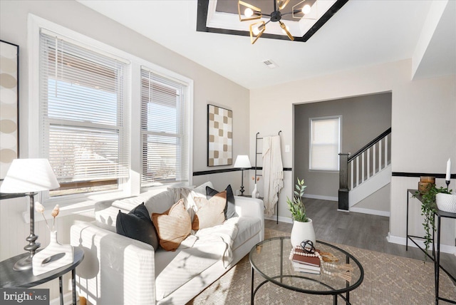 living room featuring a notable chandelier and hardwood / wood-style flooring