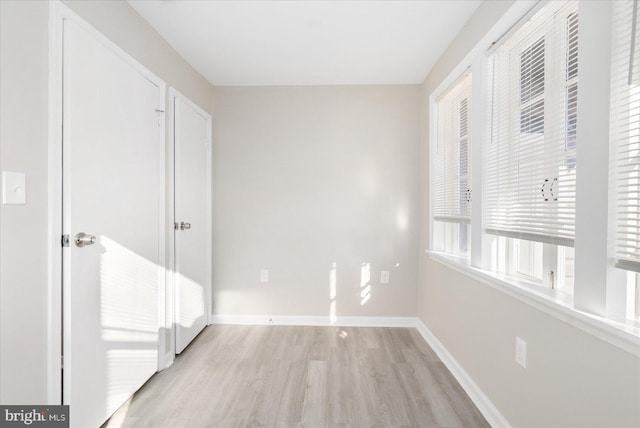 unfurnished bedroom with light wood-type flooring