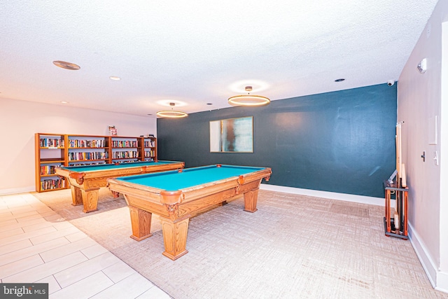 recreation room featuring light tile patterned floors, a textured ceiling, and pool table