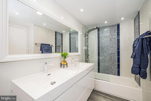 bathroom featuring vanity, bath / shower combo with glass door, and wood-type flooring