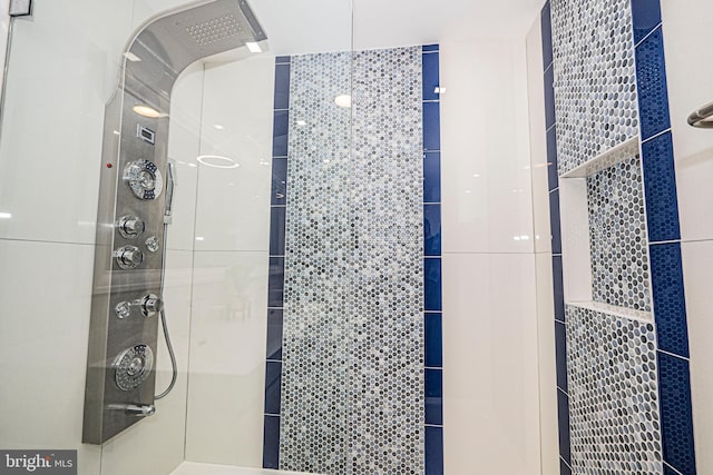 bathroom with a tile shower