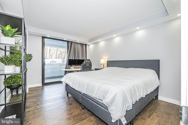 bedroom with dark hardwood / wood-style flooring and access to outside